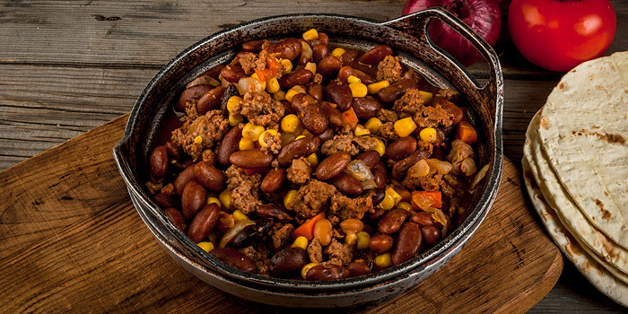 Chili in cast iron bowl on table