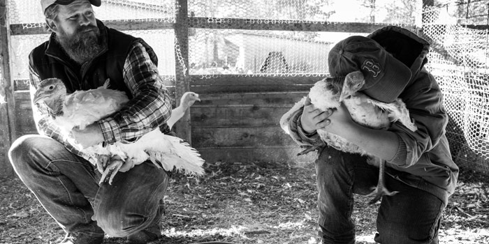 Tucker and Dennit holding turkeys