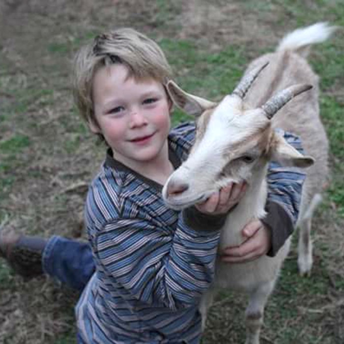 Dennet hugging a tan goat