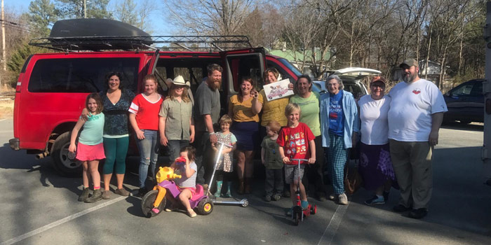 The Withingtons With Community Standing In Front Of Their New Van