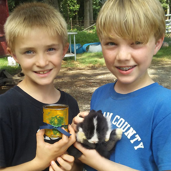 Summer camp attendees holding a baby bunny