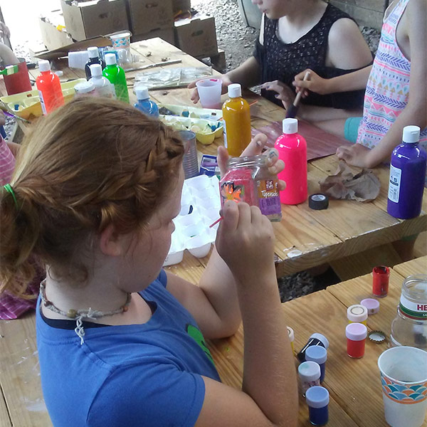 Summer camp attendee doing arts and crafts