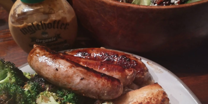 Grilled Bratwurst On Plate With Broccoli And Mustard