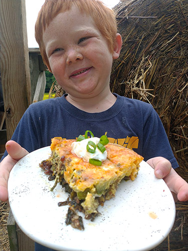 Rye holding a plate of Piggie Pie