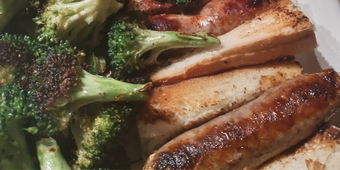 Bratwurst On Plate With Broccoli And Bread